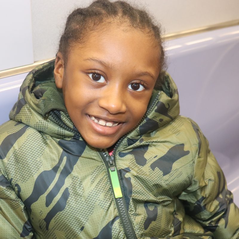 Cute,Little,Smiling,Black,Kid,Wearing,Winter,Coat,Riding,Alone